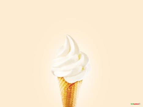 Close-up of a creamy soft serve ice cream cone on a bright background.